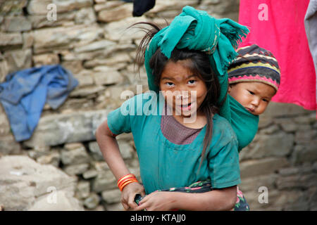 Sister's brother; A girl from Jumla is happy to pose for my camera. Stock Photo