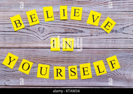 Believe in yourself printed circle inscription top view.Light wooden background. Business and motivation concept. Space for your text or image Stock Photo