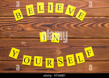 Believe in yourself printed circle inscription top view. Rustic wooden background. Business and motivation concept. Space for your text or image Stock Photo