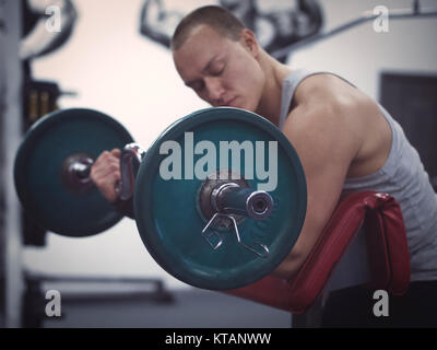 muscular man holding barbell Stock Photo