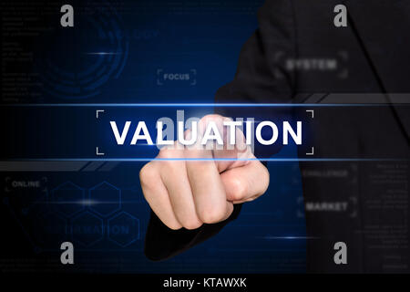 business hand pushing valuation button on virtual screen Stock Photo