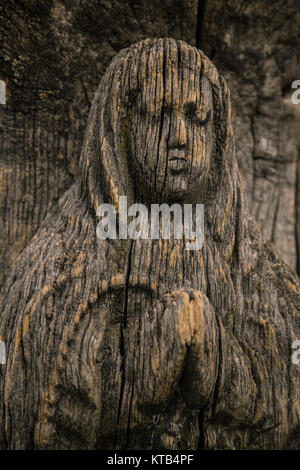Virgin Mary carved on ancient wooden icon Stock Photo