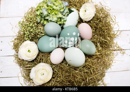 Close up with an easter nest on a white wooden table in vintage style Stock Photo