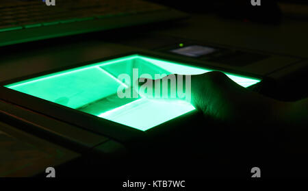 green cybersecurity digital fingerprint scanning on a green screen Stock Photo