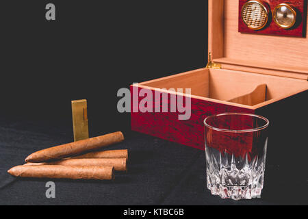 Cigar box on black background and lighter Stock Photo