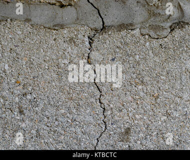 A crack in the concrete wall. The destruction of the wall from the gray blocks