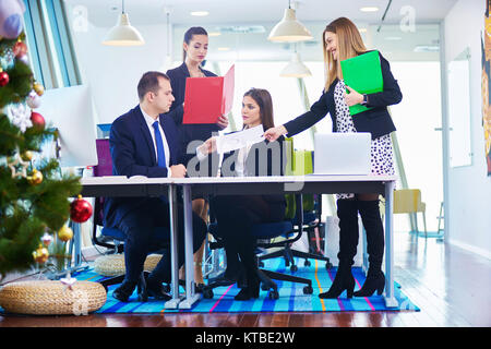 Image of business partners discussing documents and ideas at meeting in office Stock Photo