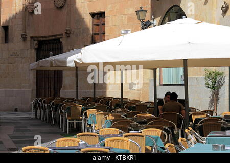 Salamanca, Spain - May 7, 2014: Two men talking on sunny afternoon on a restaurant patio in Salamanca, Spain. Stock Photo
