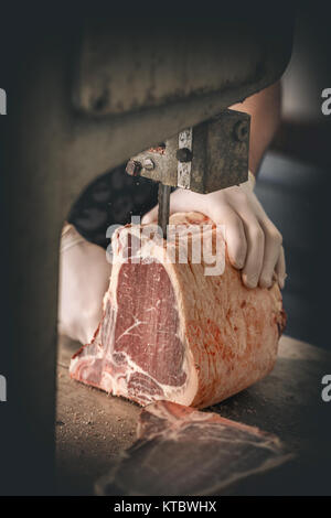 Butcher is cutting beef meat