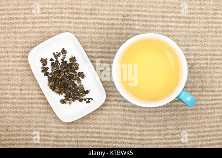 Cup of green tea on canvas tablecloth Stock Photo