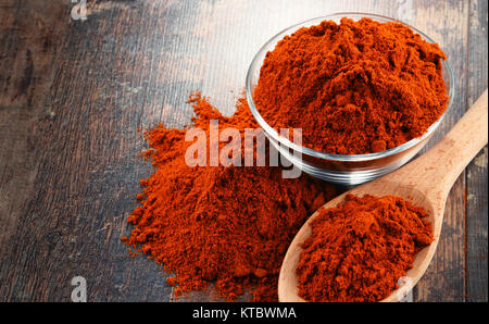 Composition with bowl of chili powder on wooden table Stock Photo