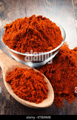 Composition with bowl of chili powder on wooden table Stock Photo