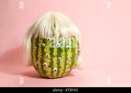 Freak watermelon wearing a wig Stock Photo