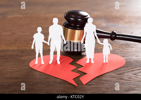 Family Paper Cut On Broken Heart With A Gavel Stock Photo