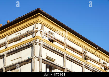 Facade of an old italian masonry building with metal tie-rod and anchor plate. Stock Photo