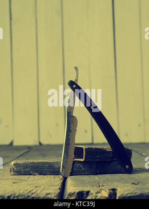 Old and rusty razor on a rustic workbench with space for text or image Stock Photo