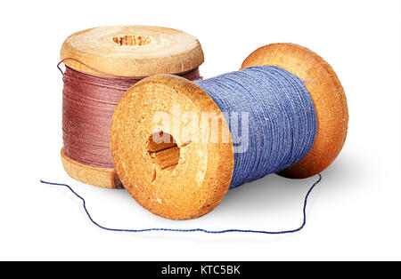 Two different colored thread on wooden spools Stock Photo