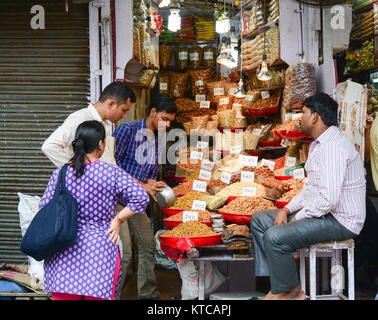 Delhi, India - Jul 26, 2015. People buying at spice shop in Delhi, India. Stock Photo