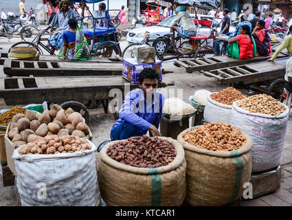 Delhi, India - Jul 26, 2015. An Indian man selling dried fruits at traditional market in Delhi, India. Stock Photo