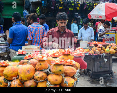 Delhi, India - Jul 26, 2015. A man selling fresh papaya fruits at the market in Delhi, India. Stock Photo