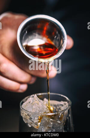 Pouring alcohol from a jigger Stock Photo