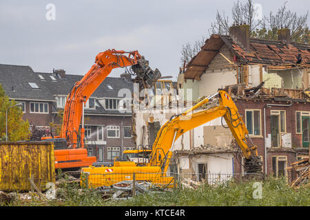 Demolition cranes demolishing old row of houses in the Netherlands