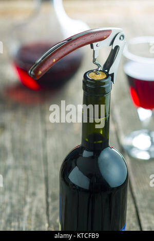 Bottle of wine with corkscrew. Stock Photo