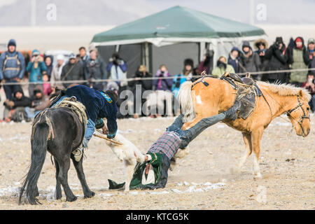 A round of Buzkashi (goat polo) at the Golden Eagle Festival in Mongolia Stock Photo