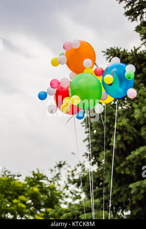 Multicolored balloons against the background of a cloudy sky Stock Photo