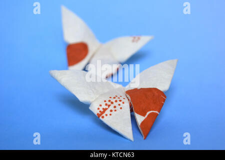 Origami butterfly on blue background Stock Photo