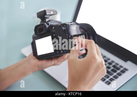 hand of photographer inserting the memory card to the camera Stock Photo