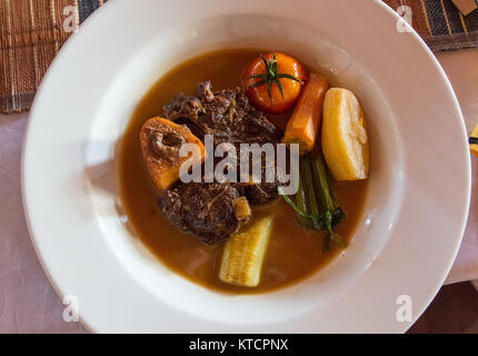 Braised beef and bone marrow, a well prepared dish served at local restaurant Mad Zebu in Belo, a small town in west Madagascar, Africa. Stock Photo