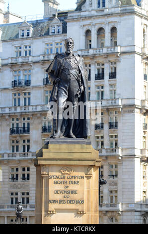 Spencer Compton Eighth Duke of Devonshire statue, Westminster, London, UK. Horse Guards Avenue with Ghurka soldier memorial beyond Stock Photo