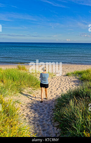 Middle aged woman going to the beach in Skane Sweden Stock Photo