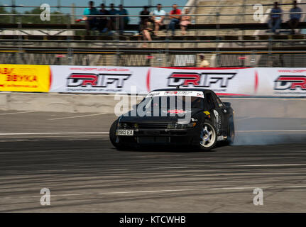 Lviv, Ukraine - Juny 6, 2015: Unknown rider on the car brand Nissan overcomes the track in the championship of Ukraine drifting in Lviv. Stock Photo