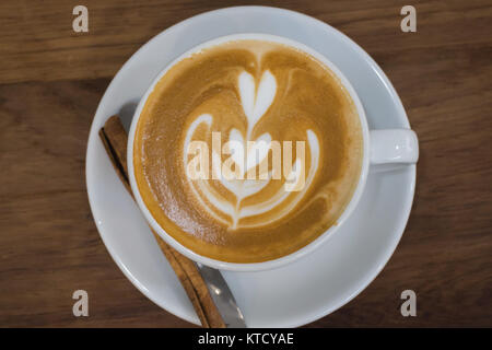 Coffee With Latte Art On Wooden Table Stock Photo