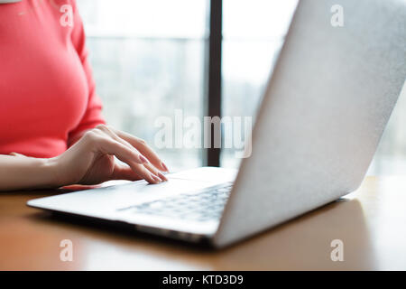 female hands typing on laptop keyboard Stock Photo