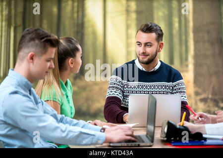 Multi ethnic group of students working on task together. Teamwork concept, diverse, team, collegues Stock Photo