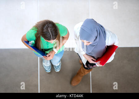 diverse group of students standing discussing school and projects, teamwork, concept Stock Photo