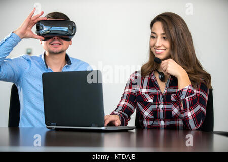 Couple having fun trying VR headset at startup meeting, concept, teamwork, fun Stock Photo