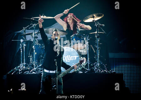 The American Christian rock band Skillet performs a live concert at Forum in Copenhagen. Here bass player and vocalist John Cooper is seen live on stage with drummer Jen Ledger in the background. Denmark, 13/11 2013. Stock Photo