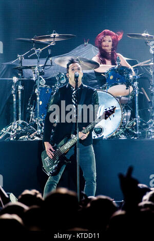 The American Christian rock band Skillet performs a live concert at Forum in Copenhagen. Here bass player and vocalist John Cooper is seen live on stage with drummer Jen Ledger in the background. Denmark, 13/11 2013. Stock Photo