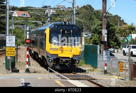 Two car Matangi electric multiple unit train arriving at Mana railway station with a Wellington to Waikanae passenger service along the NIMT in NZ. Stock Photo