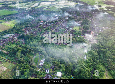 Aerial view of Pejaten Village, the main producer of traditional Balinese roof tile. Smoke is tile being burned on traditional furnace to dry it. Stock Photo