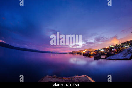 Purple twilight in the harbor of Sorowako City. The city where the Nickel mining company operate since 1960's Stock Photo