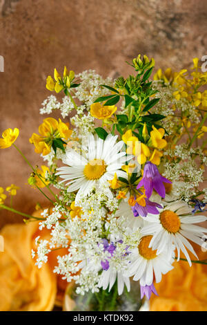 Bouquet of wild flowers in glass bottle Stock Photo