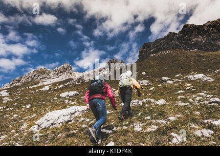 Germany, Bavaria, Oberstdorf, two hikers walking up alpine meadow Stock Photo