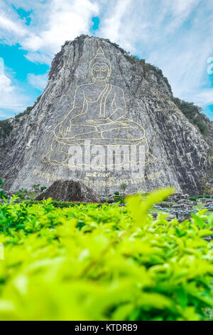 Buddha art on big cliff at public temple in Thailand Stock Photo