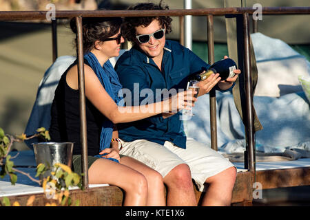 Couple on balcony of tent at Huab Under Canvas, Damaraland, Namibia, Africa Stock Photo