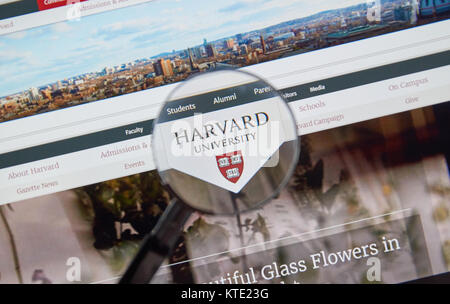 MONTREAL, CANADA - JUNE 4, 2016 : Harvard University page under magnifying glass. Harvard University is a private research university in Cambridge, Ma Stock Photo
